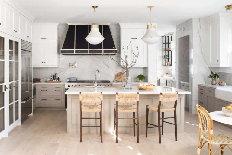 A beautifully designed kitchen showcasing natural wood cabinets, stone countertops, and layered lighting, creating a warm and inviting atmosphere for family gatherings.