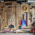Organized gardening tools stored on a wall-mounted rack and in a weather-resistant outdoor shed.