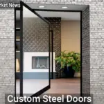 Custom Steel Doors: Strength, Style, and Security for Your Home - Your Source for the Latest Housing Trends | Housing Market News| Modern custom steel door with frosted glass panels and a sleek black finish on a suburban home’s entryway.