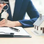 Areapatch.com Person reviewing real estate documents and mortgage papers on laptop with house keys nearby