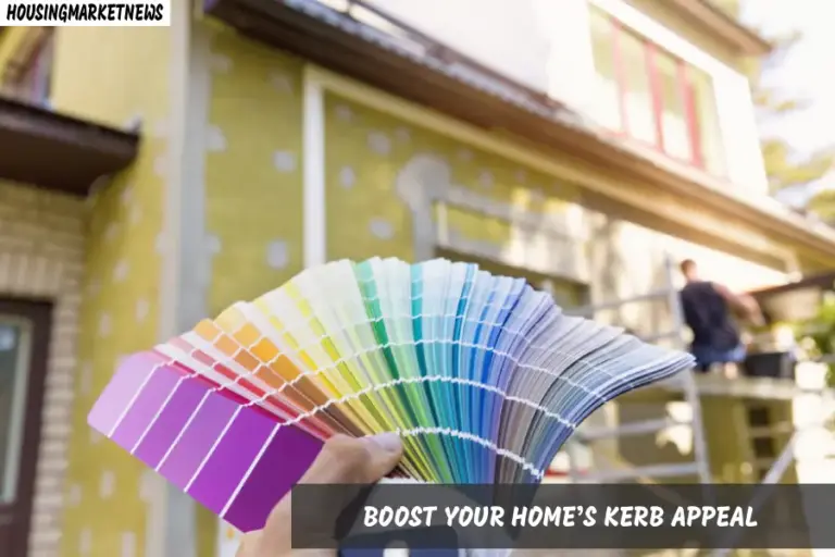 A person holds a paint color sample in front of a house, contemplating a fresh look for their home.