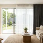Modern living room with patio door curtains and natural light filtering through glass doors