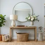 Stylish furniture table console in a modern entryway with mirror, lamp, flowers, and decorative storage