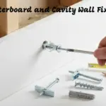 Installing a molly bolt into plasterboard with various cavity wall fixings and tools displayed.