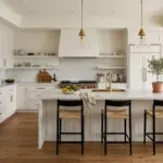 Timeless kitchen design with white shaker cabinets, marble countertops, and neutral color palette.