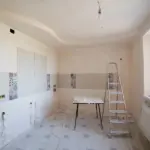 Interior room undergoing home renovation with exposed drywall and unfinished walls.