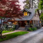 A house with a front garden and driveway at dusk