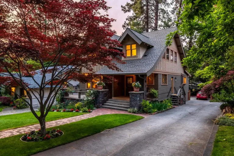 How Much Does It Cost to Move House in the UK in 2026? A house with a front garden and driveway at dusk