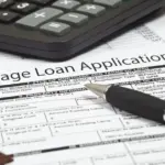 Mortgage loan application form with a calculator and pen